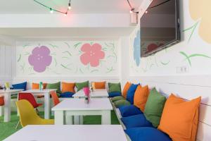 a room with a couch and tables and a tv at Flowers Hotels in Münster