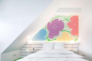 a bedroom with a flower mural on the wall at Flowers Hotels in Münster