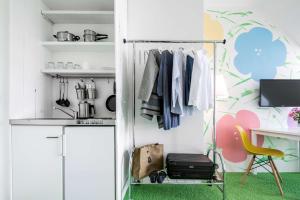 a kitchen with a closet with a desk and a chair at Flowers Hotel Münster in Münster