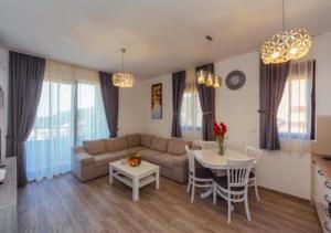 a living room with a couch and a table at Engora 5 in Petrovac na Moru