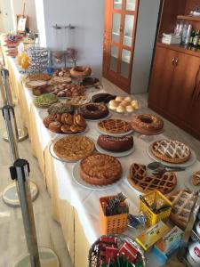 a long table filled with lots of pies and pastries at Hotel Royal in Giulianova