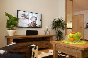 a living room with a flat screen tv on the wall at Apartment Olympia Matterhorn in Zermatt