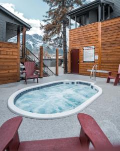 a pool with a pool table and chairs in it at Lamphouse Hotel in Canmore
