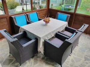 a table with chairs and a vase of flowers on it at Casa Anabella in Buşteni