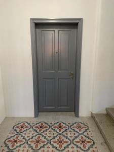 a gray door with a rug in front of it at Ipavčeva vila in Maribor