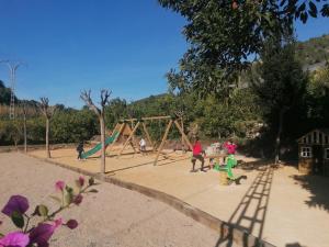 a group of people playing in a playground at El Molinet del Governador in Guadalest