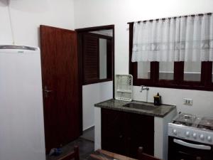 a kitchen with a sink and a stove and a window at Excellence Apart in Ubatuba