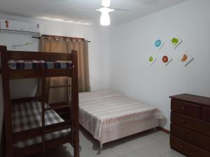 a bedroom with a bunk bed and a dresser at Village Acapulco - Itacimirim/BA in Itacimirim +69 photos