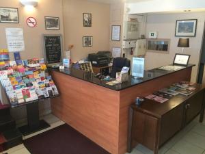 a cashier counter in a store with a cash register at Hotel Liberty in Paris