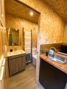 a bathroom with a sink and a tub at Pichoses Gerês Camping in Rio Caldo