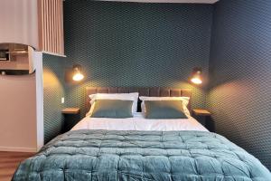 a bedroom with a bed with two pillows on it at Appart de charme Hyper-centre LIMOGES ! in Limoges