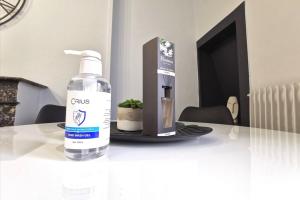 a bottle of water sitting on a table with a gift box at Coup de coeur 42 m2 ! Hyper centre LIMOGES GARE in Limoges