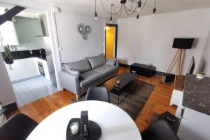 a living room with a couch and a table at Coup de coeur 42 m2 ! Hyper centre LIMOGES GARE in Limoges +20 photos