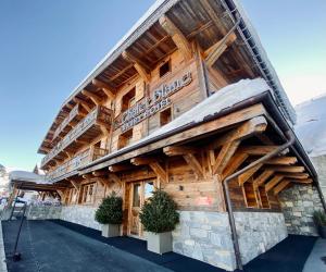 a large wooden building with a sign on it at Le Chalet Blanc in Megève