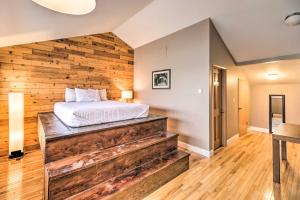 a bedroom with a wooden accent wall and a bed at Whitefish Mtn Ski-in and Out Condo Steps to Slopes! in Whitefish