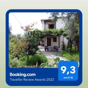 a picture of a house with a garden at Koutadelias rooms in Kalamos
