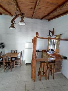 a kitchen and dining room with a table and a refrigerator at Alquimia en Las Cascadas in La Rancherita