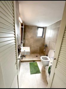 a bathroom with a white toilet and a sink at Nikaia Metro House in Piraeus