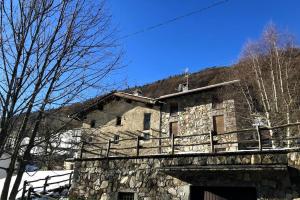 an old stone building with a bridge and trees at La Cà Granda 