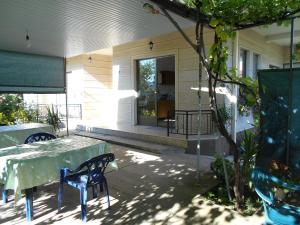 a patio with a table and chairs in front of a house at Residence Krstanoski in Ohrid