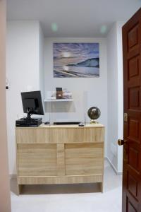 a wooden desk with a computer on top of it at B&B La Nuit in Agrigento