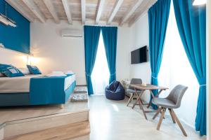 a bedroom with blue curtains and a bed and a table at Nautica Room 1 - Old Town in Dubrovnik