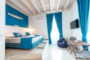 a blue bedroom with a bed and a table at Nautica Room North - Old Town in Dubrovnik +39 photos