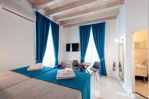 a bedroom with blue curtains and a bed with a desk at Nautica Room 1 - Old Town in Dubrovnik