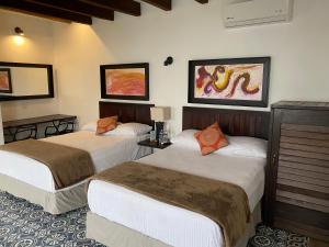 Katil atau katil-katil dalam bilik di Hotel Raices de Mar