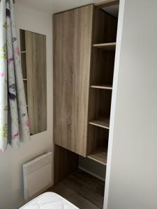 a bathroom with a wooden cabinet in a room at Luxe stacaravan in Middelkerke