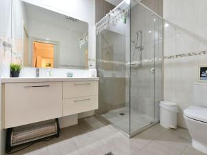 a white bathroom with a shower and a toilet at King 2 - close proximity to Bimbadgen and Hope Estate concerts in Pokolbin