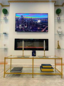 a living room with a table with a tv on a wall at Luxurious Room near LaGuardia & JFK in Corona