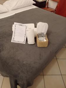 a table with towels and a basket on a bed at B&B Toscana in Pisa