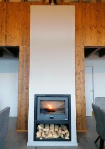 a fireplace in a room with two chairs at Apartament "El Castell" Casa Rural Cal Rialla in Llivia