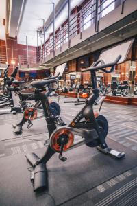 a row of exercise bikes parked in a gym at Hyatt Centric Downtown Minneapolis in Minneapolis