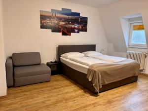 a bedroom with a bed and a chair in it at Old Town View in Cologne