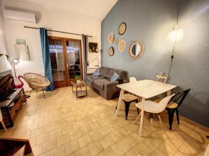 un soggiorno con un tavolo e un divano di Superbe Duplex aux Saintes terrasse plein sud 3*** a Saintes-Maries-de-la-Mer
