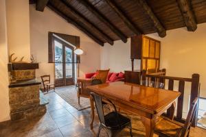 a living room with a wooden table and a couch at Casa Jarca 2on pis Àtic, a 1km de Canillo - HUT8069 in Prats