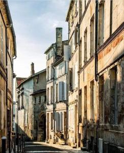 an alley in an old city with old buildings at LE DOUILLET #Centre ville #100m des quais in Cognac +15 photos
