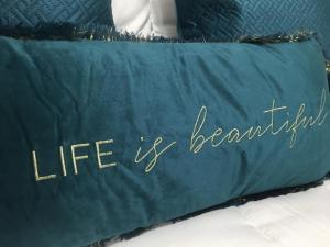 a blue blanket with the words life is beautiful at Marquês d'Aveiro Suite in Aveiro