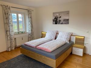 a bed in a room with a picture of a cow at Allgäu Villa in Lachen