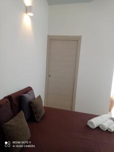 a bedroom with a bed with two towels on it at La stella di Chanel in Nardò