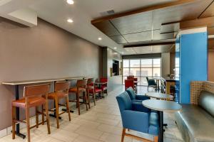 a bar with chairs and tables in a room at Holiday Inn Express Lake Worth NW Loop 820 by IHG in Fort Worth