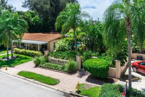 a house with a garden in front of it at Tropical Villas Of Venice Beach in Venice