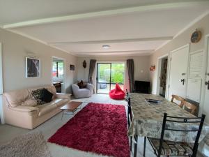 a living room with a table and a couch at 61 Conical Hill Road in Hanmer Springs