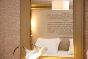 a bed with a picture of a woman on it at Best Western Plus Hotel Litteraire Gustave Flaubert in Rouen