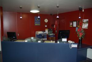 an office with a blue counter and red walls at Abbots Hamilton – Hotel and Conference Centre in Hamilton
