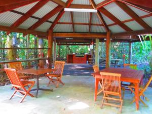 a wooden table and chairs under a pavilion at Daintree Rainforest Retreat Motel in Cape Tribulation