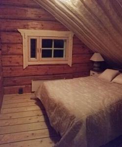 a bedroom with a bed in a log cabin at Villa Nangu in Inari