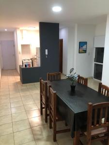 a dining room with a black table and chairs at DPTOS 3 DE FEBRERO in San Pedro
